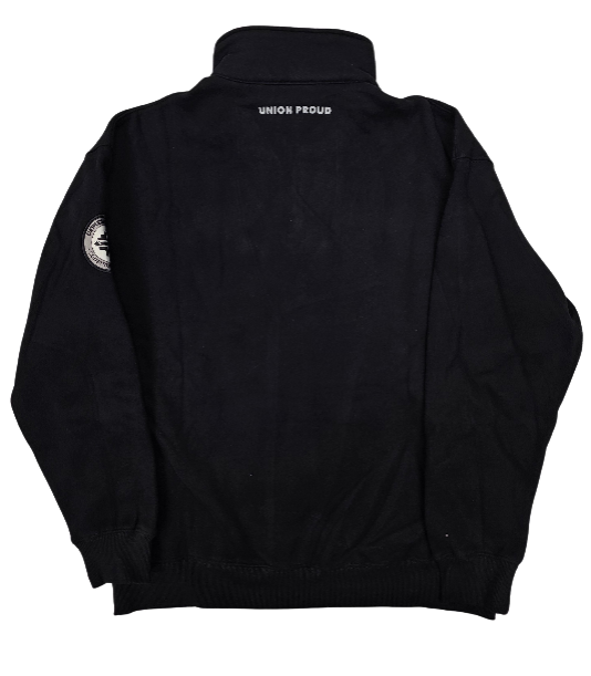 blue-logo-quarter-zip-back-OGpng | CFMEU VIC & TAS Back view of a black bomber jacket with ribbed cuffs and hem; a small white label at the collar and a circular patch on the left sleeve.