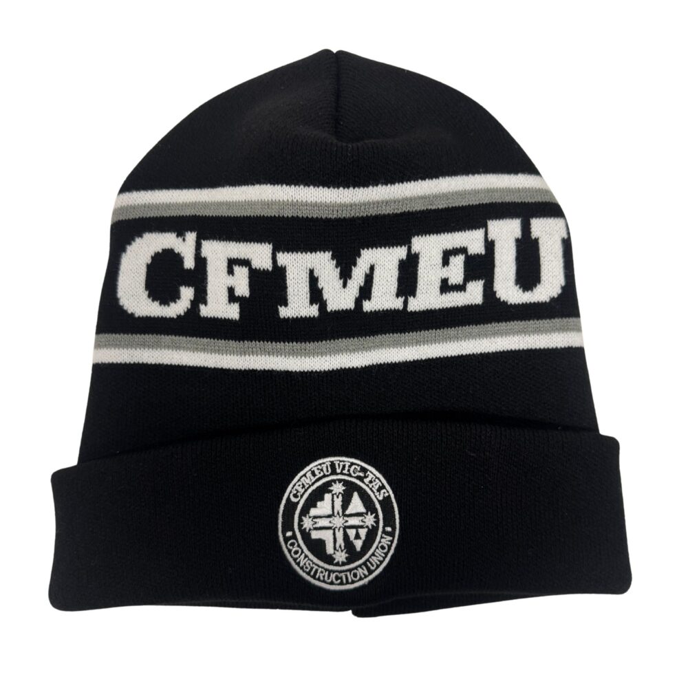 Black knit beanie with white and gray stripes and a circular emblem on the folded cuff.